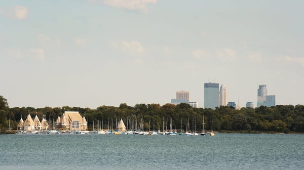 Boats on Lake Harriest with Minneapolis skyline