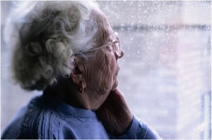 woman looking out window