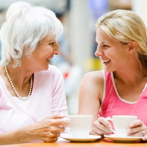 An older woman having coffee with a younger woman