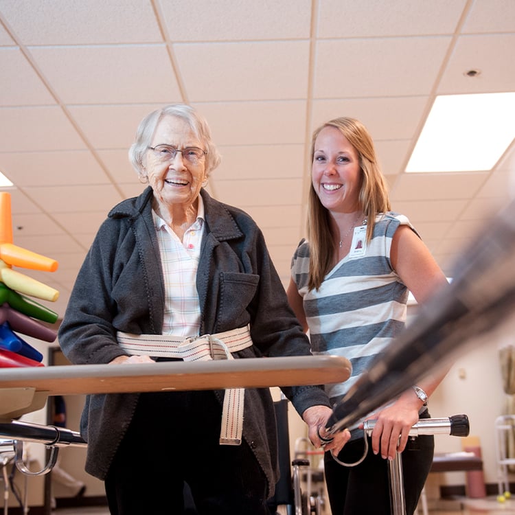 Senior standing with caretaker