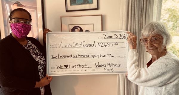 resident and nurse holding check