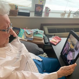 Senior talking with family through video
