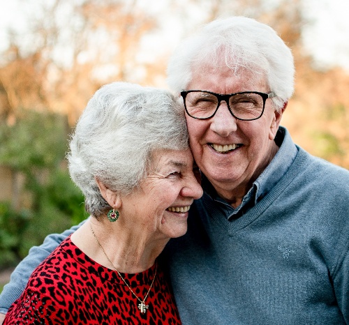 husband and wife smiling