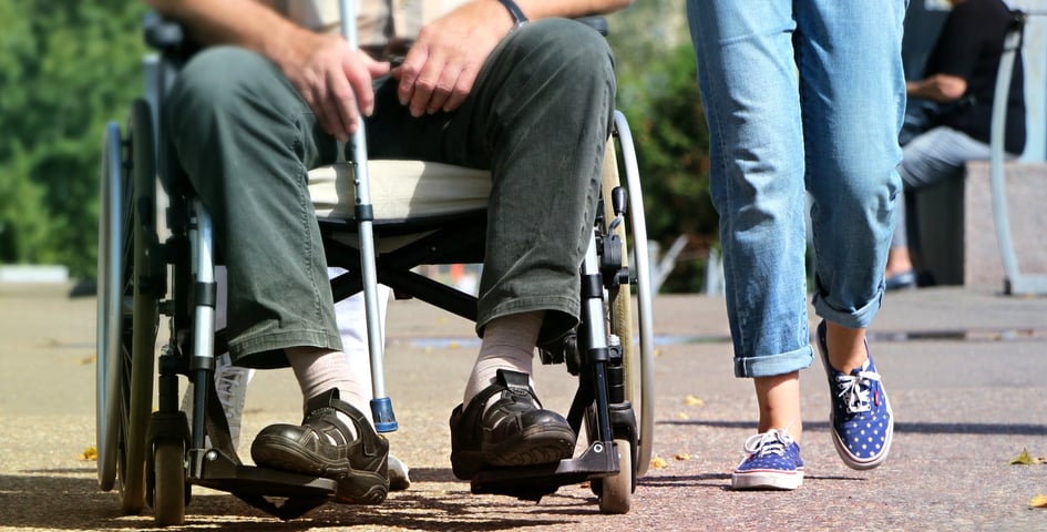 wheelchair and person walking